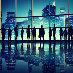 MOOC Summaries - Designing Cities - Visionary Cities - Silhouettes of business people standing in an office building.